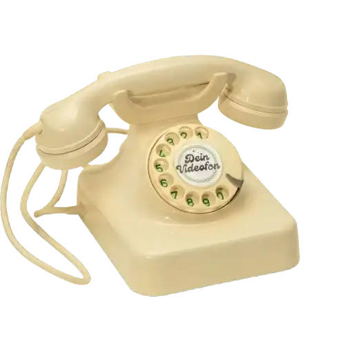 Ein beiges Wählscheibentelefon mit einer aufgewickelten Schnur und der Aufschrift Dein Videofon in der Mitte der Wählscheibe.